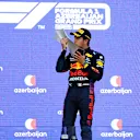 BAKU, AZERBAIJAN - JUNE 06: Race winner Sergio Perez of Mexico and Red Bull Racing celebrates on the podium during the F1 Grand Prix of Azerbaijan at Baku City Circuit on June 06, 2021 in Baku, Azerbaijan. (Photo by Dan Istitene - Formula 1/Formula 1 via Getty Images)