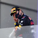 BAKU, AZERBAIJAN - JUNE 06: Race winner Sergio Perez of Mexico and Red Bull Racing celebrates with sparkling wine on the podium during the F1 Grand Prix of Azerbaijan at Baku City Circuit on June 06, 2021 in Baku, Azerbaijan. (Photo by Clive Rose/Getty Images)