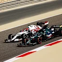 BAHRAIN, BAHRAIN - MARCH 26: Kimi Raikkonen of Finland driving the (7) Alfa Romeo Racing C41 Ferrari and Lance Stroll of Canada driving the (18) Aston Martin AMR21 Mercedes drive on track during practice ahead of the F1 Grand Prix of Bahrain at Bahrain International Circuit on March 26, 2021 in Bahrain, Bahrain. (Photo by Bryn Lennon/Getty Images)