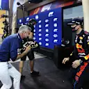 BAHRAIN, BAHRAIN - MARCH 27: Pole position qualifier Max Verstappen of Netherlands and Red Bull Racing puts a cake in the face of TV presenter and former racing driver David Coulthard in parc ferme during qualifying ahead of the F1 Grand Prix of Bahrain at Bahrain International Circuit on March 27, 2021 in Bahrain, Bahrain. (Photo by Lars Baron/Getty Images)