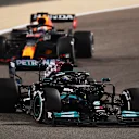 BAHRAIN, BAHRAIN - MARCH 28: Lewis Hamilton of Great Britain driving the (44) Mercedes AMG Petronas F1 Team Mercedes W12 leads Max Verstappen of the Netherlands driving the (33) Red Bull Racing RB16B Honda during the F1 Grand Prix of Bahrain at Bahrain International Circuit on March 28, 2021 in Bahrain, Bahrain. (Photo by Clive Mason - Formula 1/Formula 1 via Getty Images)