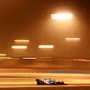 The floodlights bathe Ocon's car in a healthy glow