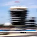 Bottas's Mercedes a blur amongst the Bahrain circuit buildings