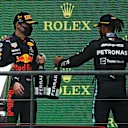SPA, BELGIUM - AUGUST 29: Race winner Max Verstappen of Netherlands and Red Bull Racing and third placed Lewis Hamilton of Great Britain and Mercedes GP celebrate on the podium during the F1 Grand Prix of Belgium at Circuit de Spa-Francorchamps on August 29, 2021 in Spa, Belgium. (Photo by Dan Mullan/Getty Images)
