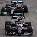 SAO PAULO, BRAZIL - NOVEMBER 13: Yuki Tsunoda of Japan driving the (22) Scuderia AlphaTauri AT02 Honda leads Lewis Hamilton of Great Britain driving the (44) Mercedes AMG Petronas F1 Team Mercedes W12 during the sprint ahead of the F1 Grand Prix of Brazil at Autodromo Jose Carlos Pace on November 13, 2021 in Sao Paulo, Brazil. (Photo by Bryn Lennon - Formula 1/Formula 1 via Getty Images)