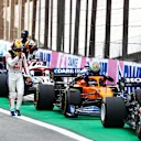 SAO PAULO, BRAZIL - NOVEMBER 13: Mick Schumacher of Germany and Haas F1 walks past Daniel Ricciardo of Australia and McLaren F1 in parc ferme during the sprint ahead of the F1 Grand Prix of Brazil at Autodromo Jose Carlos Pace on November 13, 2021 in Sao Paulo, Brazil. (Photo by Mark Thompson/Getty Images)