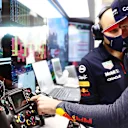 SAO PAULO, BRAZIL - NOVEMBER 13: Max Verstappen of Netherlands and Red Bull Racing talks with race engineer Gianpiero Lambiase in the garage before the sprint ahead of the F1 Grand Prix of Brazil at Autodromo Jose Carlos Pace on November 13, 2021 in Sao Paulo, Brazil. (Photo by Mark Thompson/Getty Images)