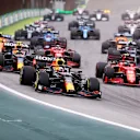 SAO PAULO, BRAZIL - NOVEMBER 13: Max Verstappen of the Netherlands driving the (33) Red Bull Racing RB16B Honda leads Sergio Perez of Mexico driving the (11) Red Bull Racing RB16B Honda and Carlos Sainz of Spain driving the (55) Scuderia Ferrari SF21 and during the sprint ahead of the F1 Grand Prix of Brazil at Autodromo Jose Carlos Pace on November 13, 2021 in Sao Paulo, Brazil. (Photo by Lars Baron/Getty Images)