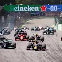 SAO PAULO, BRAZIL - NOVEMBER 14: Max Verstappen of the Netherlands driving the (33) Red Bull Racing RB16B Honda and Valtteri Bottas of Finland driving the (77) Mercedes AMG Petronas F1 Team Mercedes W12 lead the field into turn one at the start during the F1 Grand Prix of Brazil at Autodromo Jose Carlos Pace on November 14, 2021 in Sao Paulo, Brazil. (Photo by Lars Baron/Getty Images)
