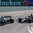 SAO PAULO, BRAZIL - NOVEMBER 14: Yuki Tsunoda of Japan driving the (22) Scuderia AlphaTauri AT02 Honda collides with Lance Stroll of Canada driving the (18) Aston Martin AMR21 Mercedes during the F1 Grand Prix of Brazil at Autodromo Jose Carlos Pace on November 14, 2021 in Sao Paulo, Brazil. (Photo by Bryn Lennon - Formula 1/Formula 1 via Getty Images)