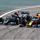 SAO PAULO, BRAZIL - NOVEMBER 14: Valtteri Bottas of Finland driving the (77) Mercedes AMG Petronas F1 Team Mercedes W12 and Max Verstappen of the Netherlands driving the (33) Red Bull Racing RB16B Honda compete for position on track at the start of the race during the F1 Grand Prix of Brazil at Autodromo Jose Carlos Pace on November 14, 2021 in Sao Paulo, Brazil. (Photo by Bryn Lennon - Formula 1/Formula 1 via Getty Images)