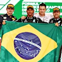 SAO PAULO, BRAZIL - NOVEMBER 14: Race winner Lewis Hamilton of Great Britain and Mercedes GP, second placed Max Verstappen of Netherlands and Red Bull Racing and third placed Valtteri Bottas of Finland and Mercedes GP celebrate on the podium during the F1 Grand Prix of Brazil at Autodromo Jose Carlos Pace on November 14, 2021 in Sao Paulo, Brazil. (Photo by Mark Thompson/Getty Images)