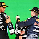SAO PAULO, BRAZIL - NOVEMBER 14: Race winner Lewis Hamilton of Great Britain and Mercedes GP and second placed Max Verstappen of Netherlands and Red Bull Racing celebrate on the podium during the F1 Grand Prix of Brazil at Autodromo Jose Carlos Pace on November 14, 2021 in Sao Paulo, Brazil. (Photo by Clive Mason - Formula 1/Formula 1 via Getty Images)