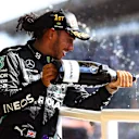 SAO PAULO, BRAZIL - NOVEMBER 14: Race winner Lewis Hamilton of Great Britain and Mercedes GP celebrates on the podium with sparkling wine during the F1 Grand Prix of Brazil at Autodromo Jose Carlos Pace on November 14, 2021 in Sao Paulo, Brazil. (Photo by Bryn Lennon - Formula 1/Formula 1 via Getty Images)