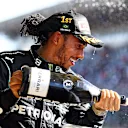 SAO PAULO, BRAZIL - NOVEMBER 14: Race winner Lewis Hamilton of Great Britain and Mercedes GP celebrates on the podium with sparkling wine during the F1 Grand Prix of Brazil at Autodromo Jose Carlos Pace on November 14, 2021 in Sao Paulo, Brazil. (Photo by Bryn Lennon - Formula 1/Formula 1 via Getty Images)