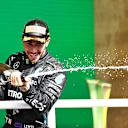SAO PAULO, BRAZIL - NOVEMBER 14: Race winner Lewis Hamilton of Great Britain and Mercedes GP celebrates on the podium with sparkling wine during the F1 Grand Prix of Brazil at Autodromo Jose Carlos Pace on November 14, 2021 in Sao Paulo, Brazil. (Photo by Buda Mendes/Getty Images)