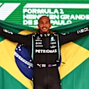 SAO PAULO, BRAZIL - NOVEMBER 14: Race winner Lewis Hamilton of Great Britain and Mercedes GP celebrates on the podium during the F1 Grand Prix of Brazil at Autodromo Jose Carlos Pace on November 14, 2021 in Sao Paulo, Brazil. (Photo by Mark Thompson/Getty Images)