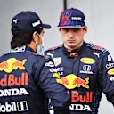 IMOLA, ITALY - APRIL 17: Second place qualifier Sergio Perez of Mexico and Red Bull Racing and third place qualifier Max Verstappen of Netherlands and Red Bull Racing talk in parc ferme during qualifying ahead of the F1 Grand Prix of Emilia Romagna at Autodromo Enzo e Dino Ferrari on April 17, 2021 in Imola, Italy. (Photo by Mark Thompson/Getty Images)