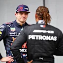 IMOLA, ITALY - APRIL 17: Third place qualifier Max Verstappen of Netherlands and Red Bull Racing talks with pole position qualifier Lewis Hamilton of Great Britain and Mercedes GP in parc ferme during qualifying ahead of the F1 Grand Prix of Emilia Romagna at Autodromo Enzo e Dino Ferrari on April 17, 2021 in Imola, Italy. (Photo by Mark Thompson/Getty Images)