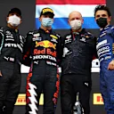 IMOLA, ITALY - APRIL 18: Second placed Lewis Hamilton of Great Britain and Mercedes GP, race winner Max Verstappen of Netherlands and Red Bull Racing, Alastair Rew, Financial Director of Red Bull Racing and third placed Lando Norris of Great Britain and McLaren F1 celebrate on the podium after the F1 Grand Prix of Emilia Romagna at Autodromo Enzo e Dino Ferrari on April 18, 2021 in Imola, Italy. (Photo by Bryn Lennon/Getty Images)