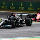 IMOLA, ITALY - APRIL 18: Lewis Hamilton of Great Britain driving the (44) Mercedes AMG Petronas F1 Team Mercedes W12 leads Charles Leclerc of Monaco driving the (16) Scuderia Ferrari SF21 on track during the F1 Grand Prix of Emilia Romagna at Autodromo Enzo e Dino Ferrari on April 18, 2021 in Imola, Italy. (Photo by Clive Mason - Formula 1/Formula 1 via Getty Images)