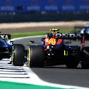 NORTHAMPTON, ENGLAND - JULY 17: Nicholas Latifi of Canada driving the (6) Williams Racing FW43B Mercedes leads Sergio Perez of Mexico driving the (11) Red Bull Racing RB16B Honda during the Sprint for the F1 Grand Prix of Great Britain at Silverstone on July 17, 2021 in Northampton, England. (Photo by Bryn Lennon - Formula 1/Formula 1 via Getty Images)