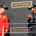 NORTHAMPTON, ENGLAND - JULY 18: Race winner Lewis Hamilton of Great Britain and Mercedes GP and second placed Charles Leclerc of Monaco and Ferrari celebrate on the podium during the F1 Grand Prix of Great Britain at Silverstone on July 18, 2021 in Northampton, England. (Photo by Bryn Lennon - Formula 1/Formula 1 via Getty Images)