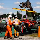 BUDAPEST, HUNGARY - JULY 31: The car of Carlos Sainz of Spain and Ferrari is removed from the track after a crash during qualifying ahead of the F1 Grand Prix of Hungary at Hungaroring on July 31, 2021 in Budapest, Hungary. (Photo by Bryn Lennon/Getty Images)