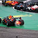 BUDAPEST, HUNGARY - AUGUST 01: Sergio Perez of Mexico driving the (11) Red Bull Racing RB16B Honda runs wide at the start as cars tangle ahead of him during the F1 Grand Prix of Hungary at Hungaroring on August 01, 2021 in Budapest, Hungary. (Photo by Bryn Lennon/Getty Images)
