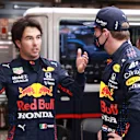 BUDAPEST, HUNGARY - AUGUST 01: Max Verstappen of Netherlands and Red Bull Racing and Sergio Perez of Mexico and Red Bull Racing talk in the garage during the red flag delay during the F1 Grand Prix of Hungary at Hungaroring on August 01, 2021 in Budapest, Hungary. (Photo by Mark Thompson/Getty Images)