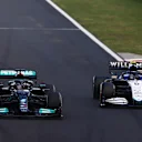 BUDAPEST, HUNGARY - AUGUST 01: Lewis Hamilton of Great Britain driving the (44) Mercedes AMG Petronas F1 Team Mercedes W12 overtakes Nicholas Latifi of Canada driving the (6) Williams Racing FW43B Mercedes during the F1 Grand Prix of Hungary at Hungaroring on August 01, 2021 in Budapest, Hungary. (Photo by Bryn Lennon/Getty Images)