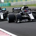 BUDAPEST, HUNGARY - AUGUST 01:Yuki Tsunoda of Japan driving the (22) Scuderia AlphaTauri AT02 Honda leads Lewis Hamilton of Great Britain driving the (44) Mercedes AMG Petronas F1 Team Mercedes W12 during the F1 Grand Prix of Hungary at Hungaroring on August 01, 2021 in Budapest, Hungary. (Photo by Joe Portlock - Formula 1/Formula 1 via Getty Images)