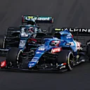 BUDAPEST, HUNGARY - AUGUST 01: Esteban Ocon of France driving the (31) Alpine A521 Renault leads Sebastian Vettel of Germany driving the (5) Aston Martin AMR21 Mercedes during the F1 Grand Prix of Hungary at Hungaroring on August 01, 2021 in Budapest, Hungary. (Photo by Bryn Lennon/Getty Images)