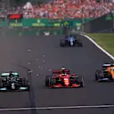 BUDAPEST, HUNGARY - AUGUST 01: Lewis Hamilton of Great Britain driving the (44) Mercedes AMG Petronas F1 Team Mercedes W12 overtakes Carlos Sainz of Spain driving the (55) Scuderia Ferrari SF21 for third place during the F1 Grand Prix of Hungary at Hungaroring on August 01, 2021 in Budapest, Hungary. (Photo by Lars Baron/Getty Images)