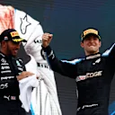 BUDAPEST, HUNGARY - AUGUST 01: Race winner Esteban Ocon of France and Alpine F1 Team celebrates on the podium next to third placed Lewis Hamilton of Great Britain and Mercedes GP during the F1 Grand Prix of Hungary at Hungaroring on August 01, 2021 in Budapest, Hungary. (Photo by Florion Goga - Pool/Getty Images)