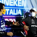 MONZA, ITALY - SEPTEMBER 12: Race winner Daniel Ricciardo of Australia and McLaren F1 and third placed Valtteri Bottas of Finland and Mercedes GP talk in the press conference after the F1 Grand Prix of Italy at Autodromo di Monza on September 12, 2021 in Monza, Italy. (Photo by Rudy Carezzevoli/Getty Images)