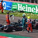 MEXICO CITY, MEXICO - NOVEMBER 06: Lance Stroll of Canada driving the (18) Aston Martin AMR21 Mercedes looks over his car after crashing during qualifying ahead of the F1 Grand Prix of Mexico at Autodromo Hermanos Rodriguez on November 06, 2021 in Mexico City, Mexico. (Photo by Hector Vivas - Formula 1/Formula 1 via Getty Images)