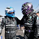 MEXICO CITY, MEXICO - NOVEMBER 06: Pole position qualifier Valtteri Bottas of Finland and Mercedes GP and second place qualifier Lewis Hamilton of Great Britain and Mercedes GP celebrate in parc ferme during qualifying ahead of the F1 Grand Prix of Mexico at Autodromo Hermanos Rodriguez on November 06, 2021 in Mexico City, Mexico. (Photo by Francisco Guasco - Pool/Getty Images)