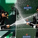 PORTIMAO, PORTUGAL - MAY 02: Race winner Lewis Hamilton of Great Britain and Mercedes GP and third placed Valtteri Bottas of Finland and Mercedes GP celebrate with sparkling wine on the podium after the F1 Grand Prix of Portugal at Autodromo Internacional Do Algarve on May 02, 2021 in Portimao, Portugal. (Photo by Gabriel Bouys - Pool/Getty Images)