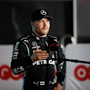DOHA, QATAR - NOVEMBER 20: Third place qualifier Valtteri Bottas of Finland and Mercedes GP talks to the media in parc ferme during qualifying ahead of the F1 Grand Prix of Qatar at Losail International Circuit on November 20, 2021 in Doha, Qatar. (Photo by Hamad I Mohammed - Pool/Getty Images)