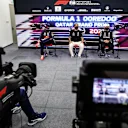 DOHA, QATAR - NOVEMBER 20: Pole position qualifier Lewis Hamilton of Great Britain and Mercedes GP, second placed qualifier Max Verstappen of Netherlands and Red Bull Racing and third placed qualifier Valtteri Bottas of Finland and Mercedes GP talk in a press conference after qualifying ahead of the F1 Grand Prix of Qatar at Losail International Circuit on November 20, 2021 in Doha, Qatar. (Photo by Florent Gooden - Pool/Getty Images)