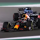 DOHA, QATAR - NOVEMBER 21: Max Verstappen of the Netherlands driving the (33) Red Bull Racing RB16B Honda leads Fernando Alonso of Spain driving the (14) Alpine A521 Renault during the F1 Grand Prix of Qatar at Losail International Circuit on November 21, 2021 in Doha, Qatar. (Photo by Lars Baron/Getty Images)