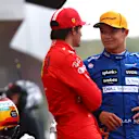 SOCHI, RUSSIA - SEPTEMBER 25: Pole position qualifier Lando Norris of Great Britain and McLaren F1 talks with second place qualifier Carlos Sainz of Spain and Ferrari in parc ferme during qualifying ahead of the F1 Grand Prix of Russia at Sochi Autodrom on September 25, 2021 in Sochi, Russia. (Photo by Dan Istitene - Formula 1/Formula 1 via Getty Images)
