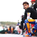 SOCHI, RUSSIA - SEPTEMBER 26: Lando Norris of Great Britain and McLaren F1 kneels in support of the We Race As One initiative before the F1 Grand Prix of Russia at Sochi Autodrom on September 26, 2021 in Sochi, Russia. (Photo by Dan Istitene - Formula 1/Formula 1 via Getty Images)