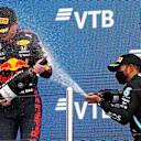 SOCHI, RUSSIA - SEPTEMBER 26: Race winner Lewis Hamilton of Great Britain and Mercedes GP celebrates on the podium with second placed Max Verstappen of Netherlands and Red Bull Racing during the F1 Grand Prix of Russia at Sochi Autodrom on September 26, 2021 in Sochi, Russia. (Photo by Yuri Kochetkov - Pool/Getty Images)