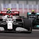 SOCHI, RUSSIA - SEPTEMBER 26: Antonio Giovinazzi of Italy driving the (99) Alfa Romeo Racing C41 Ferrari leads Valtteri Bottas of Finland driving the (77) Mercedes AMG Petronas F1 Team Mercedes W12 during the F1 Grand Prix of Russia at Sochi Autodrom on September 26, 2021 in Sochi, Russia. (Photo by Lars Baron - Formula 1/Formula 1 via Getty Images)