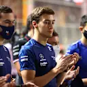 JEDDAH, SAUDI ARABIA - DECEMBER 05: Nicholas Latifi of Canada and Williams and George Russell of Great Britain and Williams pay tribute to the late Sir Frank Williams with the rest of the F1 community ahead of the F1 Grand Prix of Saudi Arabia at Jeddah Corniche Circuit on December 05, 2021 in Jeddah, Saudi Arabia. (Photo by Bryn Lennon - Formula 1/Formula 1 via Getty Images)