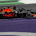 JEDDAH, SAUDI ARABIA - DECEMBER 05: Max Verstappen of the Netherlands driving the (33) Red Bull Racing RB16B Honda and Lewis Hamilton of Great Britain driving the (44) Mercedes AMG Petronas F1 Team Mercedes W12 battle for track position at the restart during the F1 Grand Prix of Saudi Arabia at Jeddah Corniche Circuit on December 05, 2021 in Jeddah, Saudi Arabia. (Photo by Mark Thompson/Getty Images)