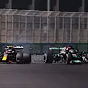 JEDDAH, SAUDI ARABIA - DECEMBER 05: Max Verstappen of the Netherlands driving the (33) Red Bull Racing RB16B Honda and Lewis Hamilton of Great Britain driving the (44) Mercedes AMG Petronas F1 Team Mercedes W12 collide during the F1 Grand Prix of Saudi Arabia at Jeddah Corniche Circuit on December 05, 2021 in Jeddah, Saudi Arabia. (Photo by Lars Baron/Getty Images)