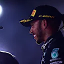 JEDDAH, SAUDI ARABIA - DECEMBER 05: Race winner Lewis Hamilton of Great Britain and Mercedes GP and third placed Valtteri Bottas of Finland and Mercedes GP celebrate on the podium during the F1 Grand Prix of Saudi Arabia at Jeddah Corniche Circuit on December 05, 2021 in Jeddah, Saudi Arabia. (Photo by Mario Renzi - Formula 1/Formula 1 via Getty Images)